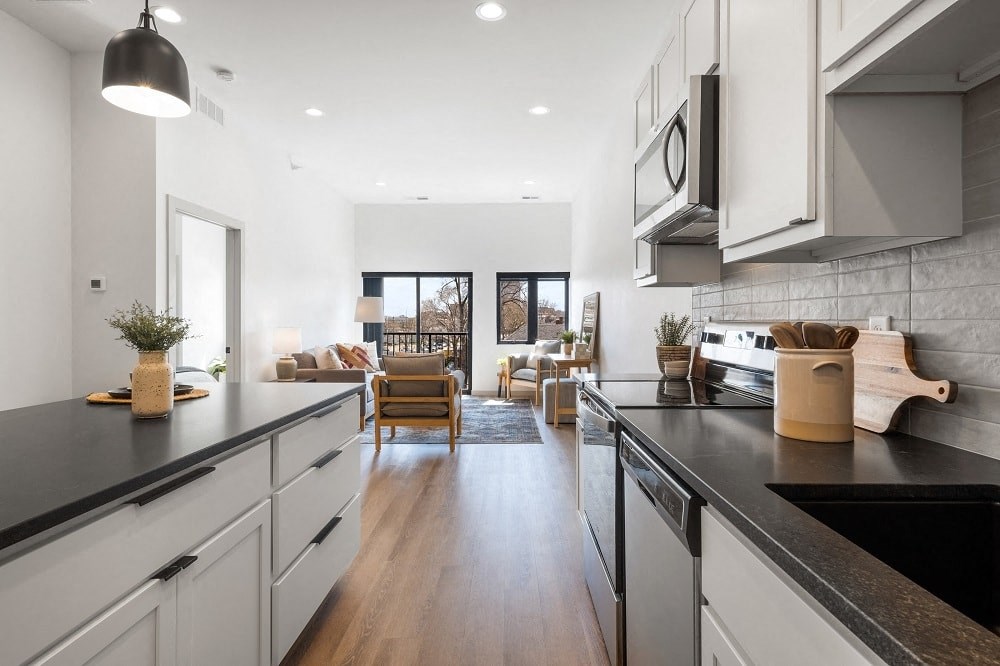 Spacious Apartment Kitchen with Dishwasher, oversized sink, kitchen island, microwave and oven cooktop range