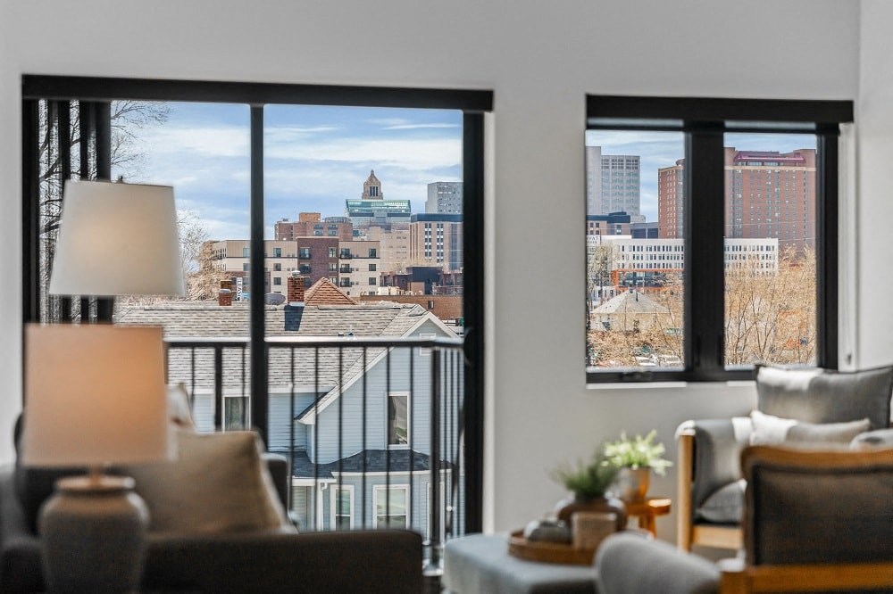 a living room with a view of the city from a balcony