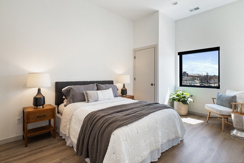 a bedroom with a bed and a window