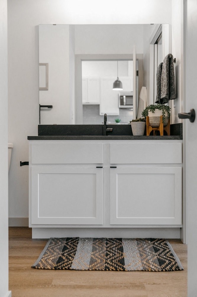 a white bathroom with a sink and a mirror