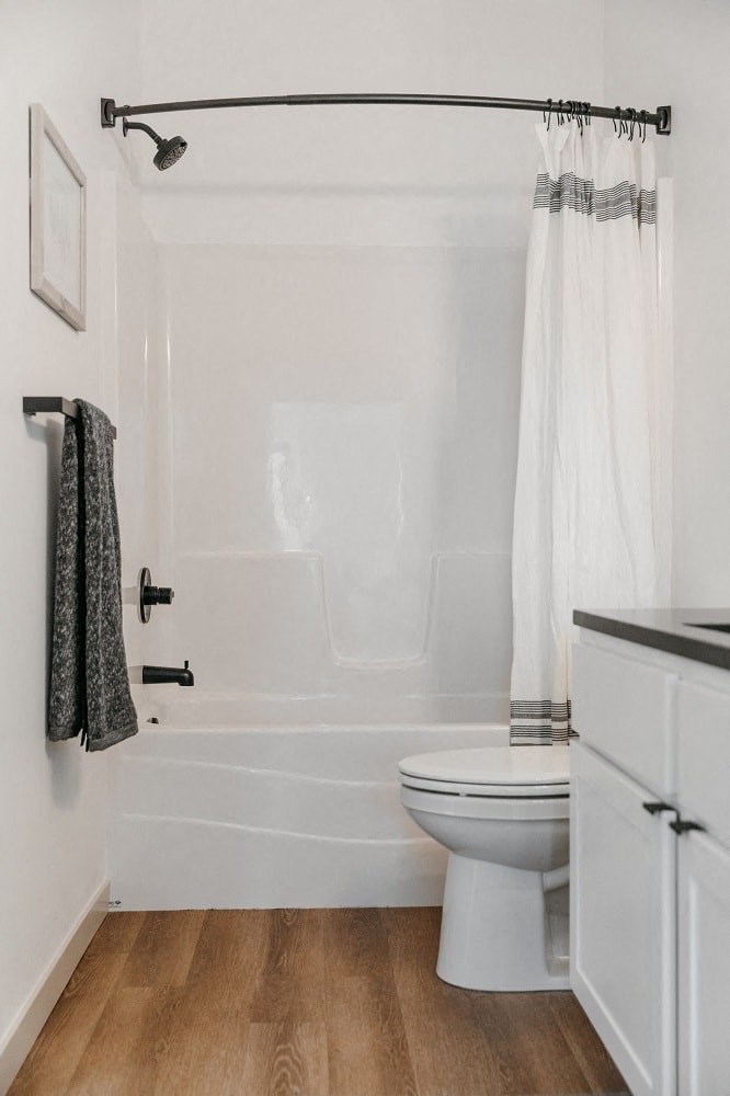 a spacious bathroom with full bath and modern fixtures