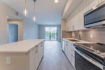 Kitchen with White Cabinets and Appliances	at Mayla Pompano, Pompano Beach, 33062