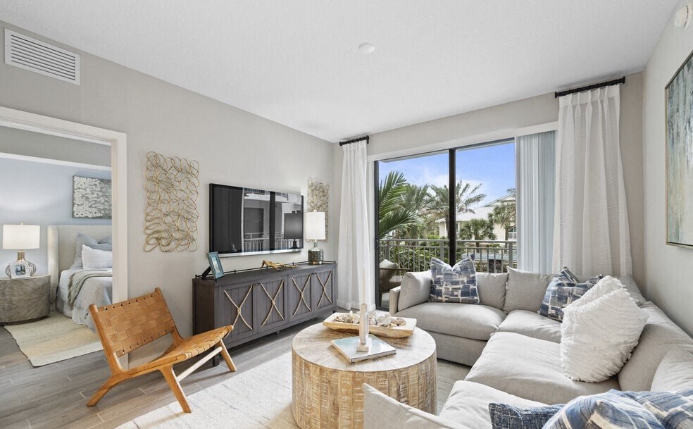 a living room with a couch and a tv at Mayla Pompano, Pompano Beach, FL