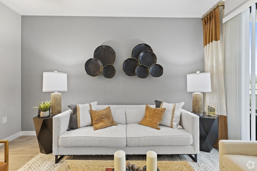 a living room with a couch and pots on the wall at Mayla Pompano, Pompano Beach, Florida