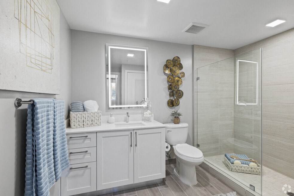 a white bathroom with a shower toilet and sink at Mayla Pompano, Pompano Beach, 33062