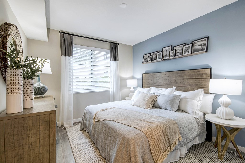 A bedroom with a large bed and a wooden headboard at Mayla Pompano, Pompano Beach, Florida