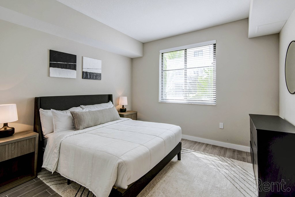 A bedroom with a large bed and a window with blinds at Mayla Pompano, Florida, 33062