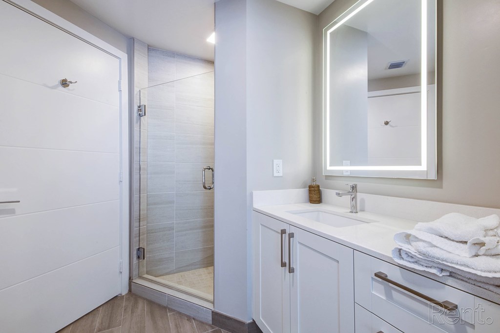 A bathroom with a white sink and a white shower at Mayla Pompano, Pompano Beach, FL