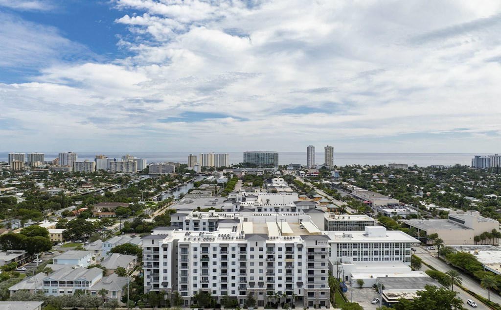 A large white building is in the center of a cityscape at Mayla Pompano, Pompano Beach, 33062