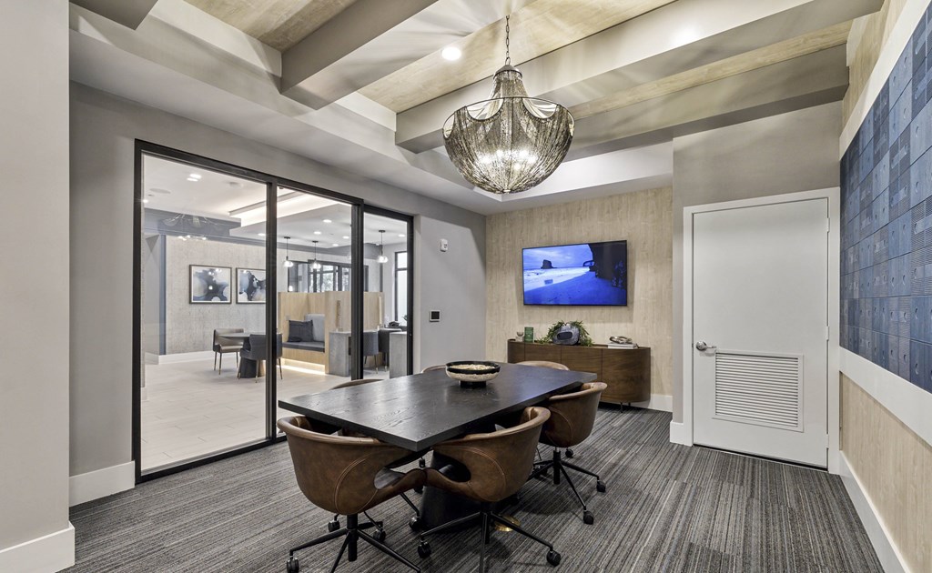 A conference room with a large table and chairs at Mayla Pompano, Pompano Beach, FL