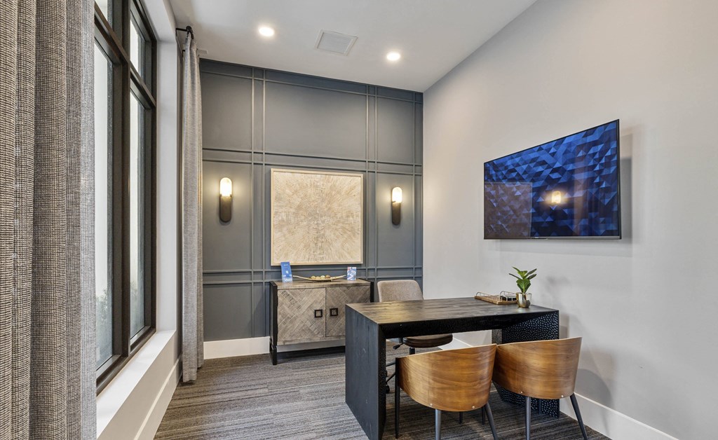 A modern dining room with a dark table and chairs at Mayla Pompano, Pompano Beach, FL, 33062
