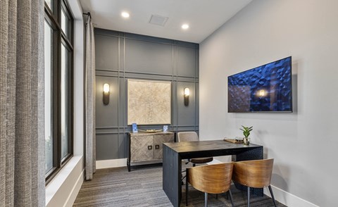 A modern dining room with a dark table and chairs at Mayla Pompano, Pompano Beach, FL, 33062