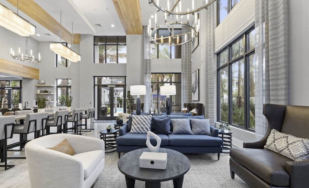 A modern living room with a variety of seating options and a chandelier at Mayla Pompano, Pompano Beach, 33062