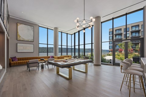 A modern living room with a large table and chairs.