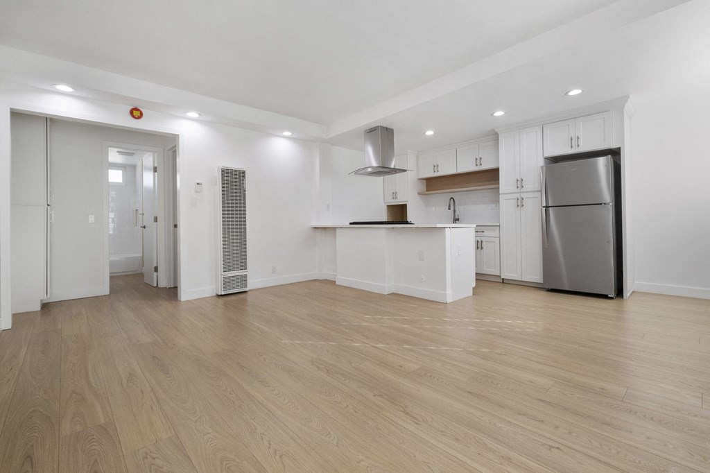 A kitchen with a refrigerator, stove, and cabinets at Arlington Square Apartment , California, 90501