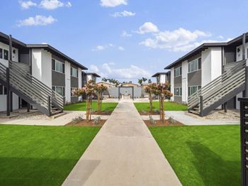 a view of a row of houses with grass and pathways at Charle Square Apartments