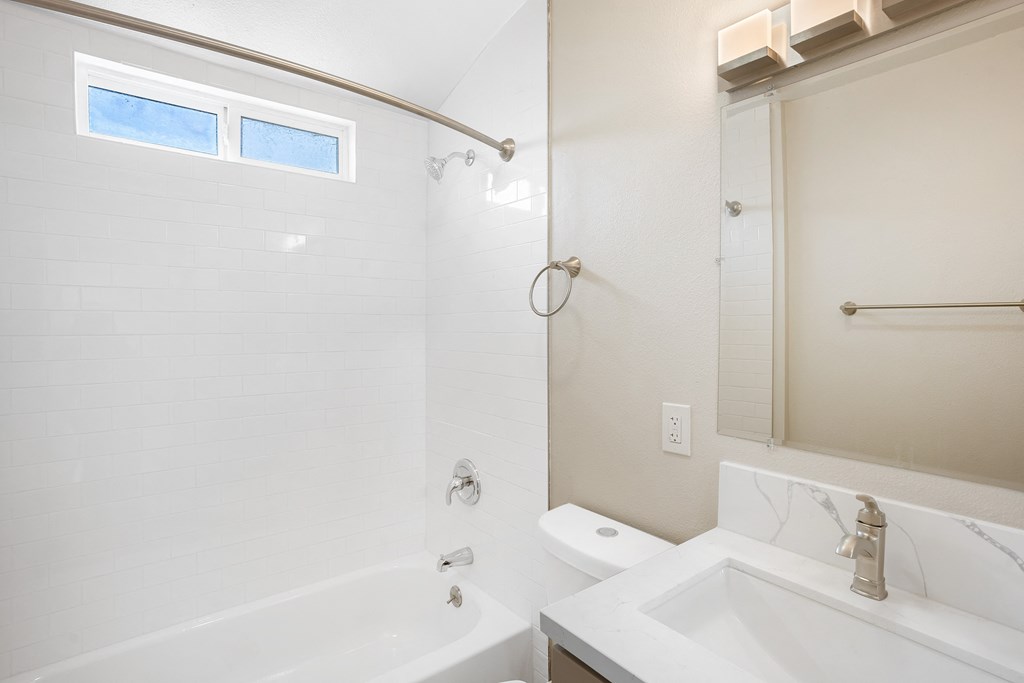 a bathroom with a tub sink and shower and a mirror at Huntington Manor Homes Apartment, Huntington Beach, CA, 92648