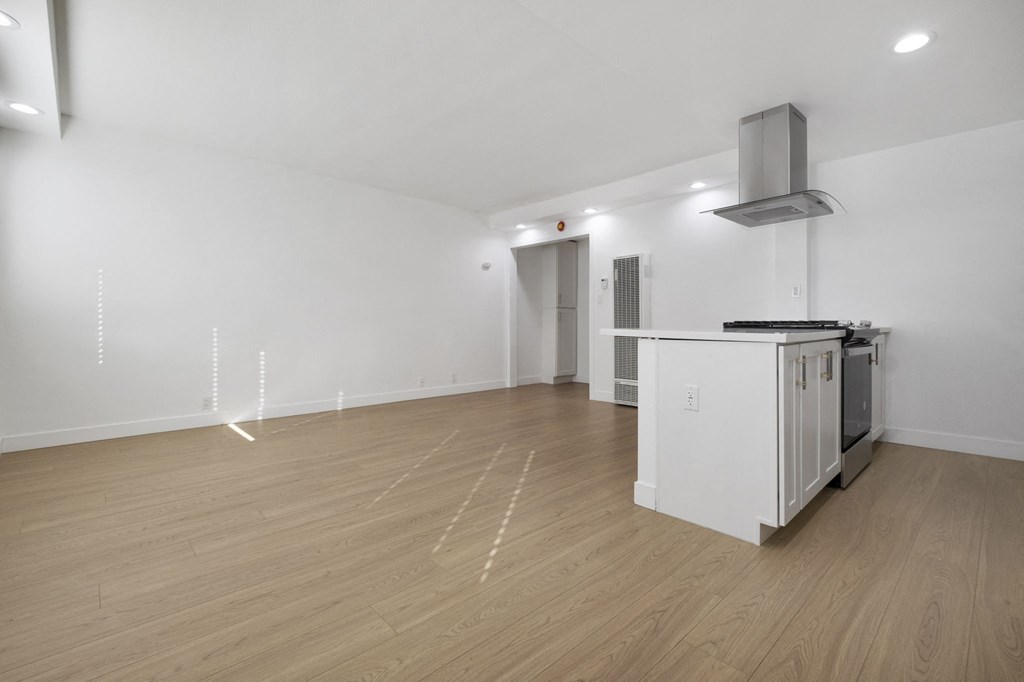A kitchen area with a white cabinet and a stove top oven at Arlington Square Apartment , Torrance