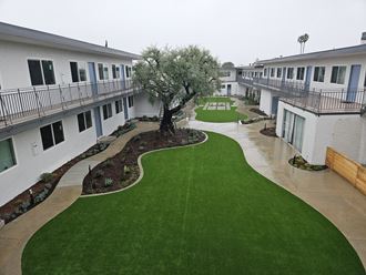 an aerial view of the courtyard of an apartment building