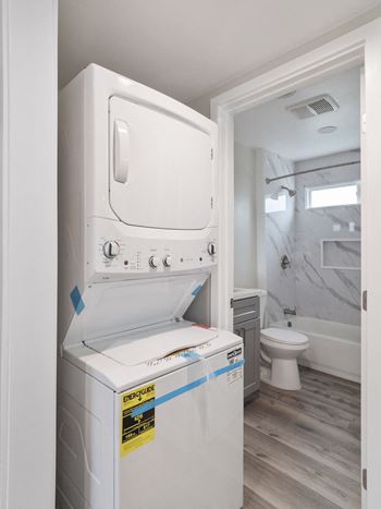 stackable white washer and dryer set at Charle Square Apartments