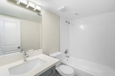 a bathroom with a sink toilet and a tub