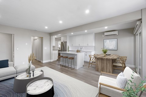 A modern living room with a grey sofa and a wooden coffee table.