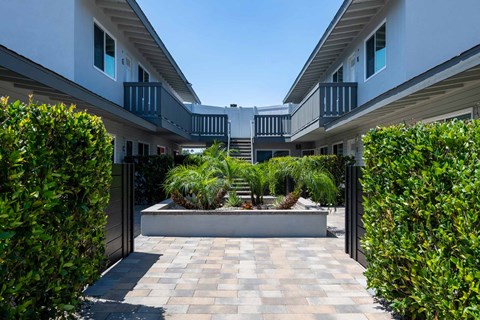 Courtyard with Paved Walkway at Eastside Haven at 17th Apartments, Costa Mesa, California