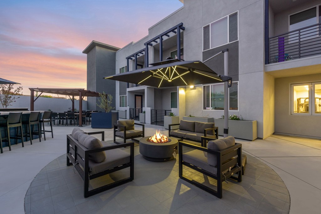A patio with a fire pit and seating area.at The Reserve La Mirada, California