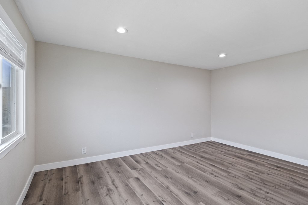 an empty room with wood floors and white walls at Charle Square Apartments, Costa Mesa, 92627