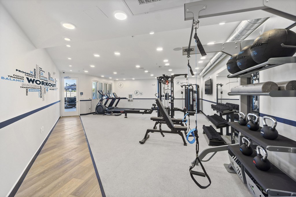 A gym with a variety of equipment including weights and machines.at The Reserve La Mirada, California, 90638