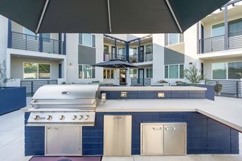 A modern outdoor kitchen with a grill and sink.at The Reserve La Mirada, La Mirada, California