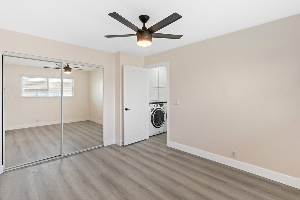 a bedroom with a large window and a ceiling fan at Seaview Terrace Apartment Homes, San Clemente