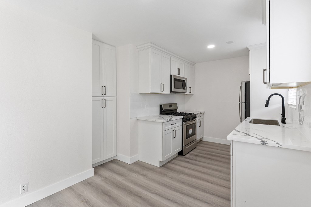 a kitchen with white cabinetry and stainless steel appliances at Seaview Terrace Apartment Homes, San Clemente, CA