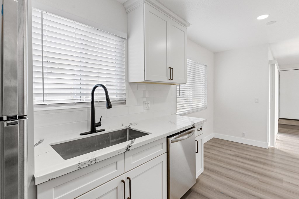 a kitchen with white cabinets and a stainless steel dishwasher at Seaview Terrace Apartment Homes, San Clemente, CA, 92672