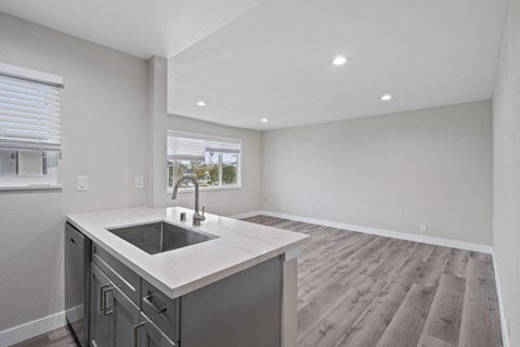 the kitchen is open to the living room and dining room
