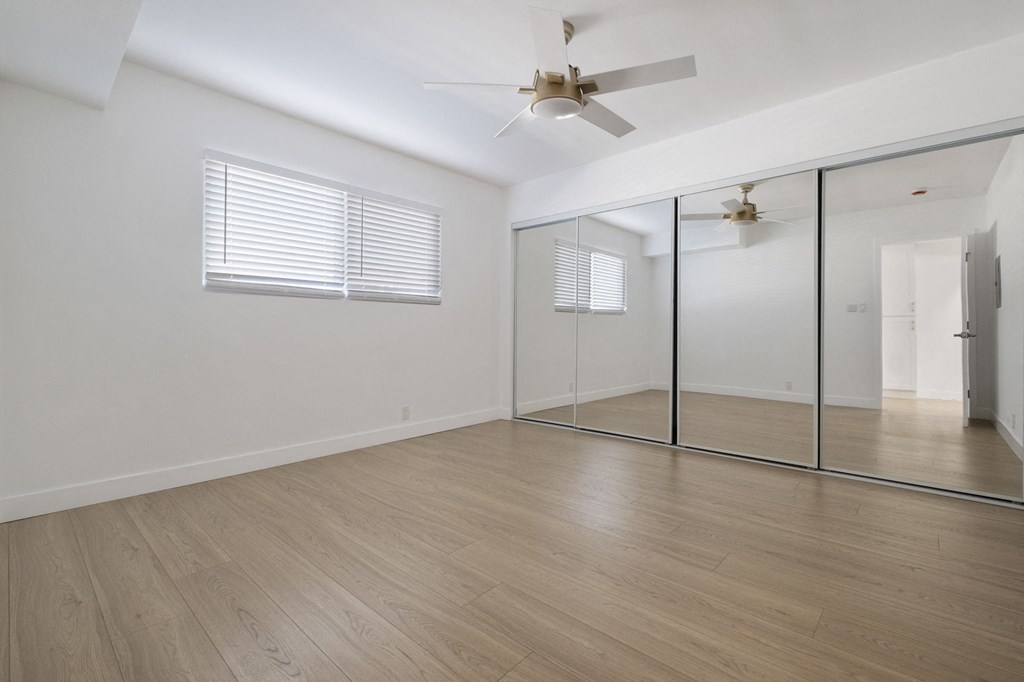 A room with a ceiling fan and mirrored walls at Arlington Square Apartment , Torrance, CA