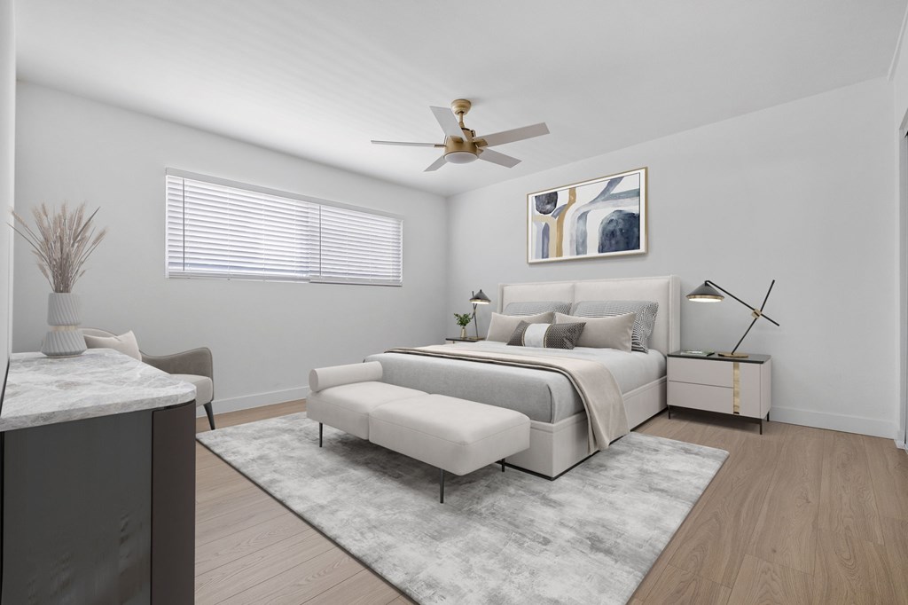 A bedroom with a bed, a bench, and a side table.