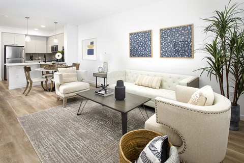 A modern living room with a white sofa and a glass coffee table.