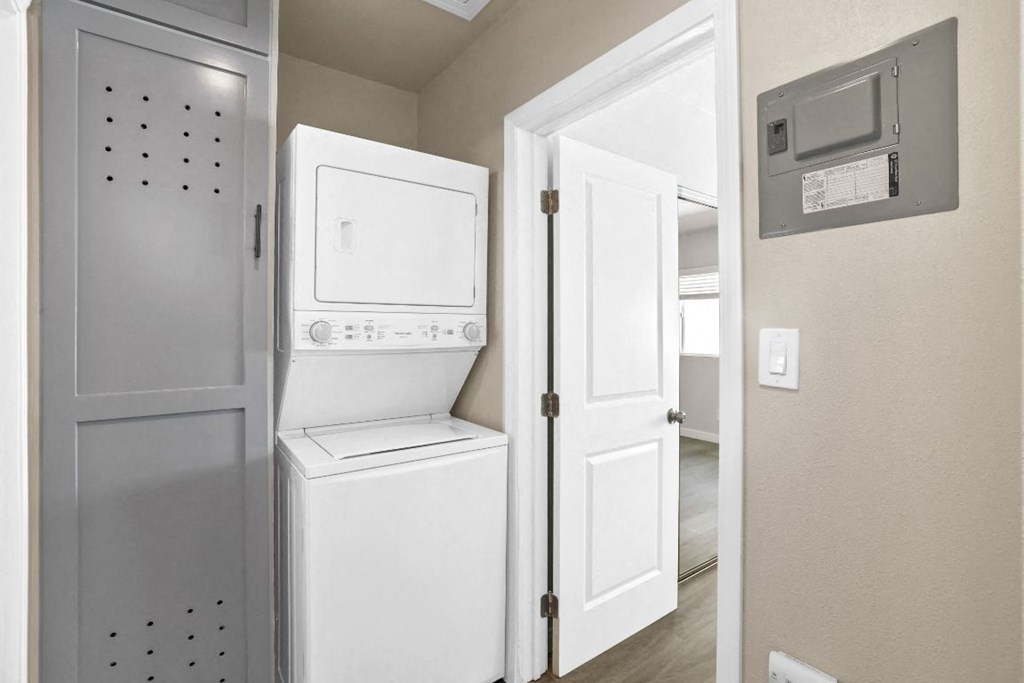 a laundry room with a washer and dryer and a door to a closet