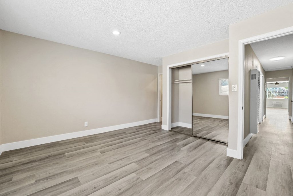 the spacious living room and dining room are open to the hallway and kitchen