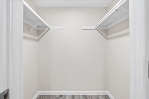 an empty room with white walls and a white closet