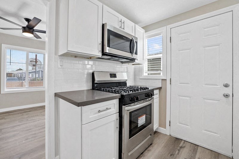 a kitchen with a stove and a microwave at Huntington Manor Homes Apartment, Huntington Beach
