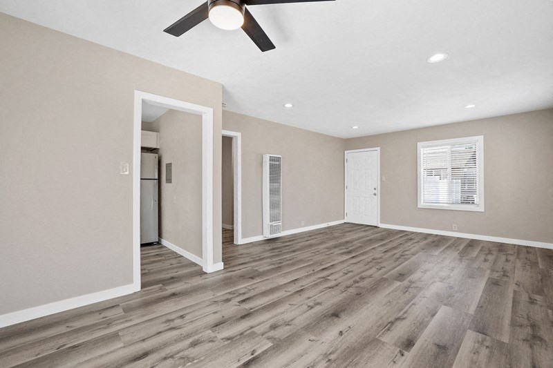 an empty living room with a ceiling fan at Huntington Manor Homes Apartment, Huntington Beach, CA