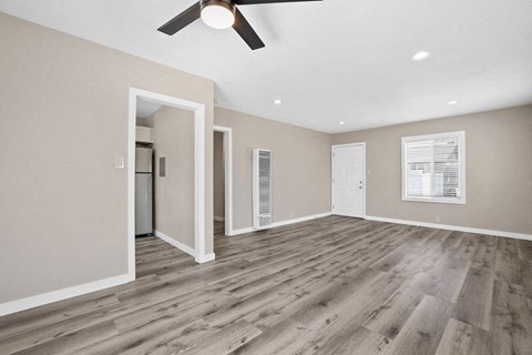 the living room of a new home with a ceiling fan