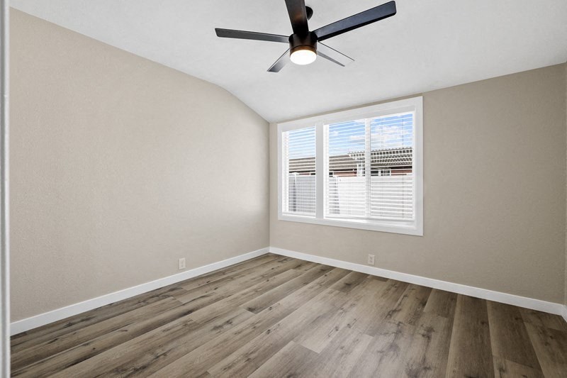 an empty bedroom with a ceiling fan and window at Huntington Manor Homes Apartment, Huntington Beach, 92648