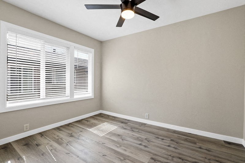 an empty bedroom with a ceiling fan and window at Huntington Manor Homes Apartment, Huntington Beach, CA, 92648