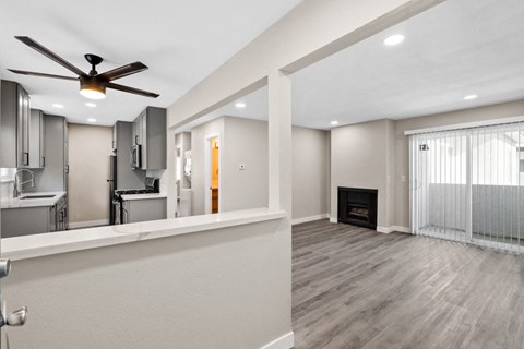 a living room with a ceiling fan and a fireplace