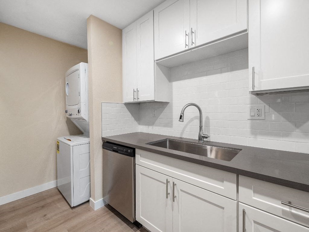 a kitchen with white cabinets and a sink