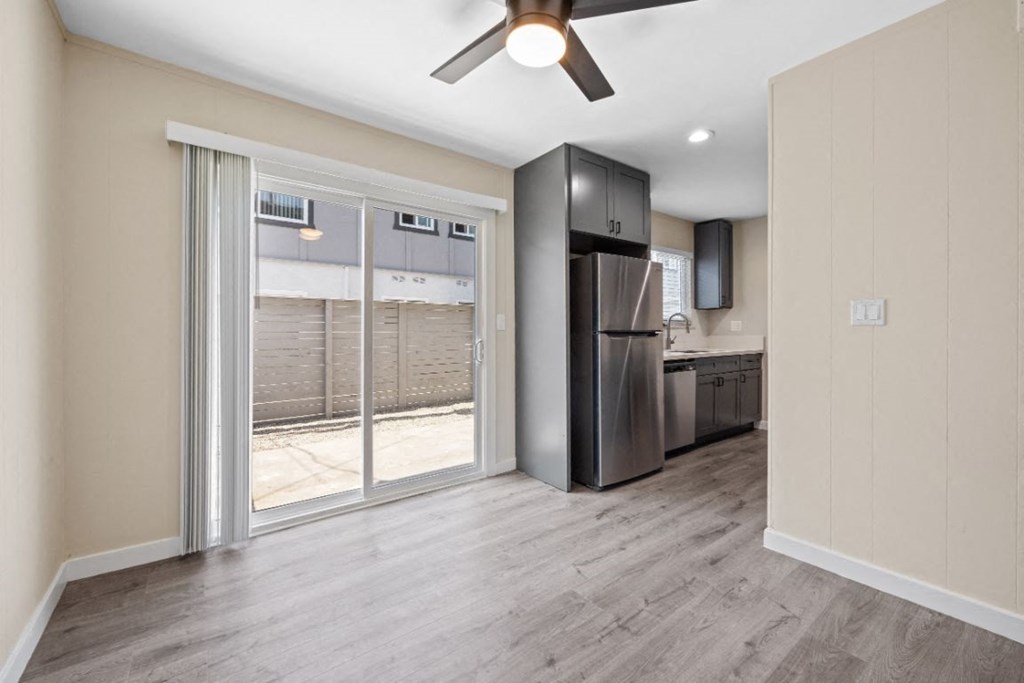 a living room and kitchen with a sliding glass door