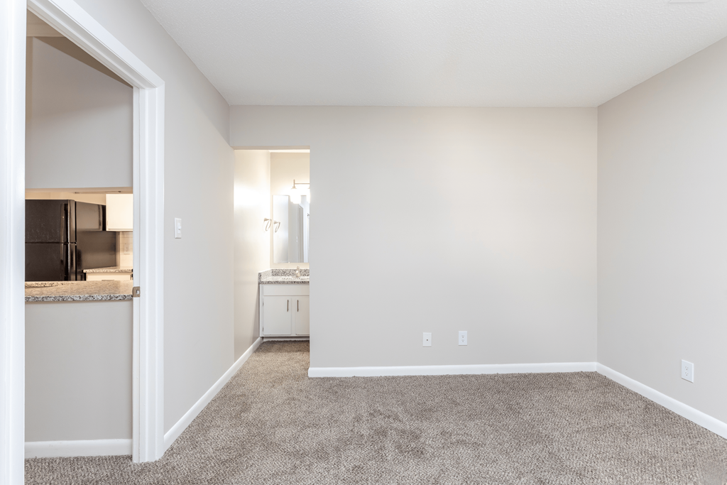 A kitchen area with a refrigerator, microwave, and oven.